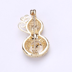 Detail view showing secure pin mechanism and hollowed gold hulu brooch with zircons
