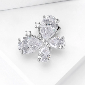 Macro shot of silver butterfly brooch with pear-cut crystals and fine zircon detailing