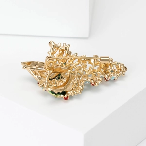 Back view of gold-plated Christmas tree brooch with colorful enamel and secure safety pin