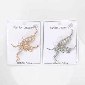 Detailed view of fairy brooches with sparkling zircons in gold and silver finish
