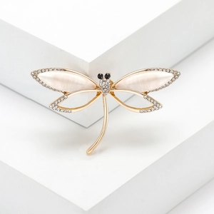 Elegant dragonfly brooch with opal wings and sparkling crystals on a golden metal base