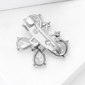 Detail view showing the silver metal pin clasp and back structure of a butterfly brooch