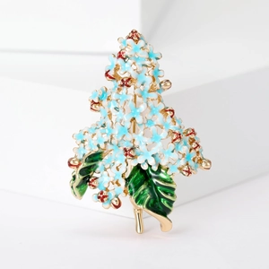 Detailed close-up of blue enamel hydrangea brooch with gold leaves and floral textures