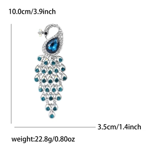 Elegant silver peacock brooch with sparkling blue rhinestones measuring 10x3.5cm