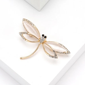Detail of dragonfly brooch with gold-tone alloy base, cat-eye wings and sparkling rhinestones
