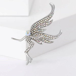 Macro shot of silver fairy brooch with sparkling cubic zirconia on a white platform