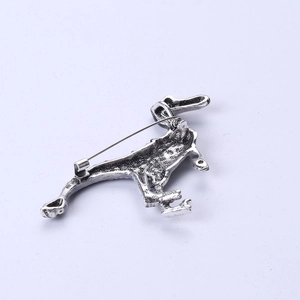 Detailed back view of vintage silver dinosaur brooch with sturdy metal pin buckle