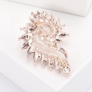 Rose gold swirl brooch with pearl and zircon detail, featuring a secure safety pin back