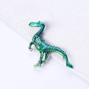 Detail of vibrant green enamel dinosaur brooch with realistic scale texture and silver metal