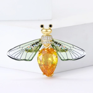 Exquisite gold-toned bee brooch featuring a faceted yellow gemstone and pavé zircon wings