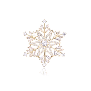 Macro view of crystal snowflake brooch with 18K gold plating and cubic zirconia