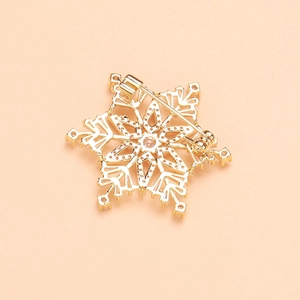 Macro shot of the snowflake brooch back with gold plating and safety pin mechanism