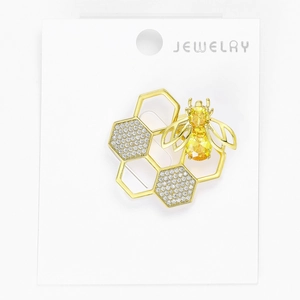 Close-up of golden honeybee brooch with yellow crystal abdomen and rhinestone honeycomb