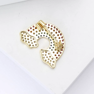 Elegant gold leopard brooch with colorful crystals and a secure pin fastening