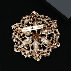 Detail view of the gold-plated hollow sunflower brooch back with secure pin clasp