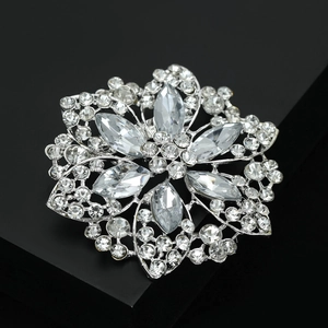 Macro shot of silver flower brooch with crystal rhinestones on a black background