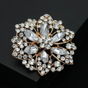 Close-up of sparkling sunflower crystal brooch with marquise rhinestones and gold setting