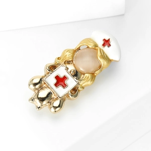 Fashionable nurse brooch with white enamel, cat-eye stone, and golden metal finish