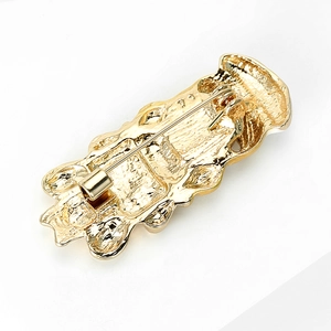 Golden nurse brooch back view showing secure rotating locking pin and textured metal finish