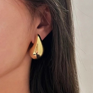Minimalist golden teardrop earrings with a high-gloss polished mirror finish for women