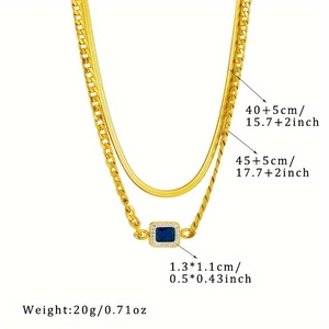 Detail of layered gold necklace with blue gemstone pendant and length measurements