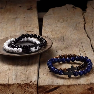 8mm natural agate and tiger eye beaded bracelet set with cross charms on wood surface