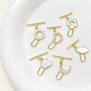 18k gold-plated OT toggles with mother of pearl in heart, moon, and Hamsa shapes