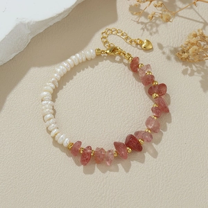 Detailed macro view of baroque pearl bracelet with pink strawberry quartz and lobster clasp