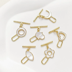 Detailed view of 18k gold plated OT toggles with mother of pearl inlays in various shapes