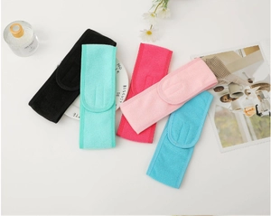 Detail of five microfiber spa headbands in various colors with adjustable velcro strap