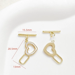 Macro view of 18k gold plated heart OT toggle clasp with white shell inlay details