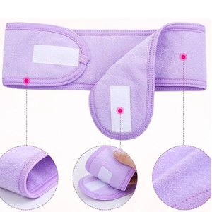 Detailed close-up showing purple coral fleece spa headband with adjustable velcro closure