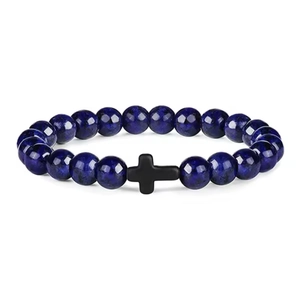 Close-up of 8mm deep blue lapis beads and matte black cross charm on elastic bracelet