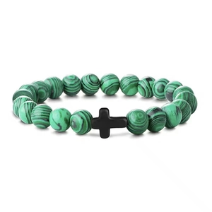 Close-up of 8mm green malachite beads and smooth black cross pendant on the bracelet