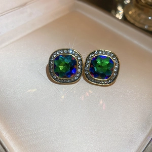 Macro view of vintage style square emerald-cut iridescent gemstone stud earrings