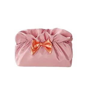 Pink satin cosmetic bag with orange ribbon bow and large capacity for travel use