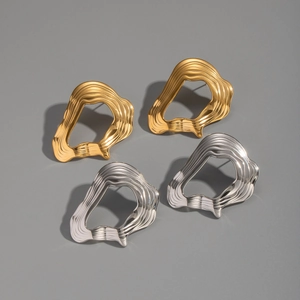 Polished gold and silver irregular lava earrings with organic textured design