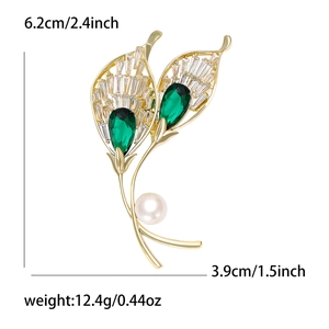 Elegant gold-tone leaf brooch with emerald stones, zircon accents and a white pearl