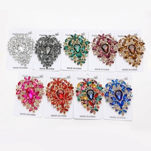 Macro detail of nine vintage flower brooches with colorful rhinestones in a crystal display