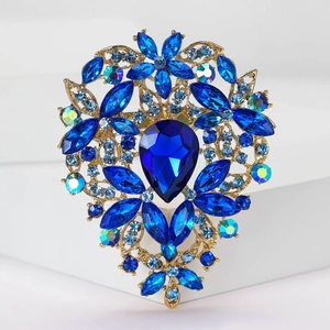 Detailed macro shot of vintage heart brooch with dark blue crystals and AB rhinestones