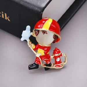 Detailed macro shot of creative enamel firefighter brooch with opal face and crystal hydrant