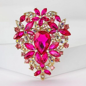 Close-up of luxury heart floral brooch with pink rhinestones and magenta gemstones