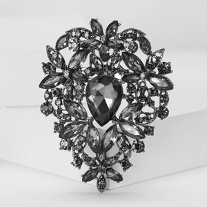 Detail of vintage heart brooch with grey crystals and large teardrop centerpiece