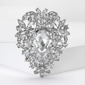 Detail view of large teardrop crystal and silver base on the floral rhinestone brooch