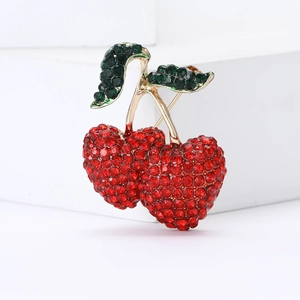 Exquisite cartoon cherry brooch with sparkling red and green crystals on a gold alloy base