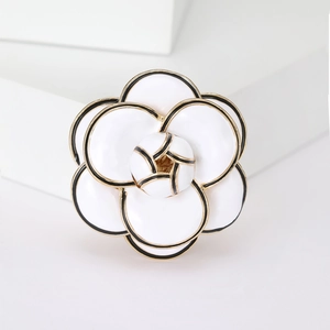 Elegant white enamel camellia brooch with black outlines and gold alloy finish