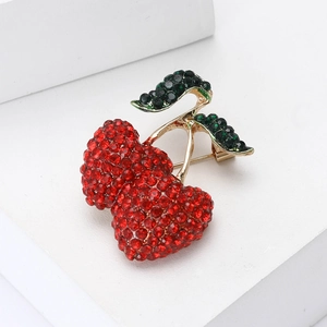 Elegant cherry brooch with red and green crystals set in a gold-tone metal base