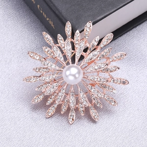Luxury sunflower brooch in rose gold with a center pearl and sparkling rhinestone crystals