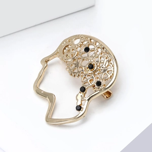 Macro shot of gold steampunk brain brooch showing intricate hollow gear design and details