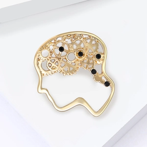 Detailed steampunk gold metal brain brooch with gear mechanism and black rhinestones